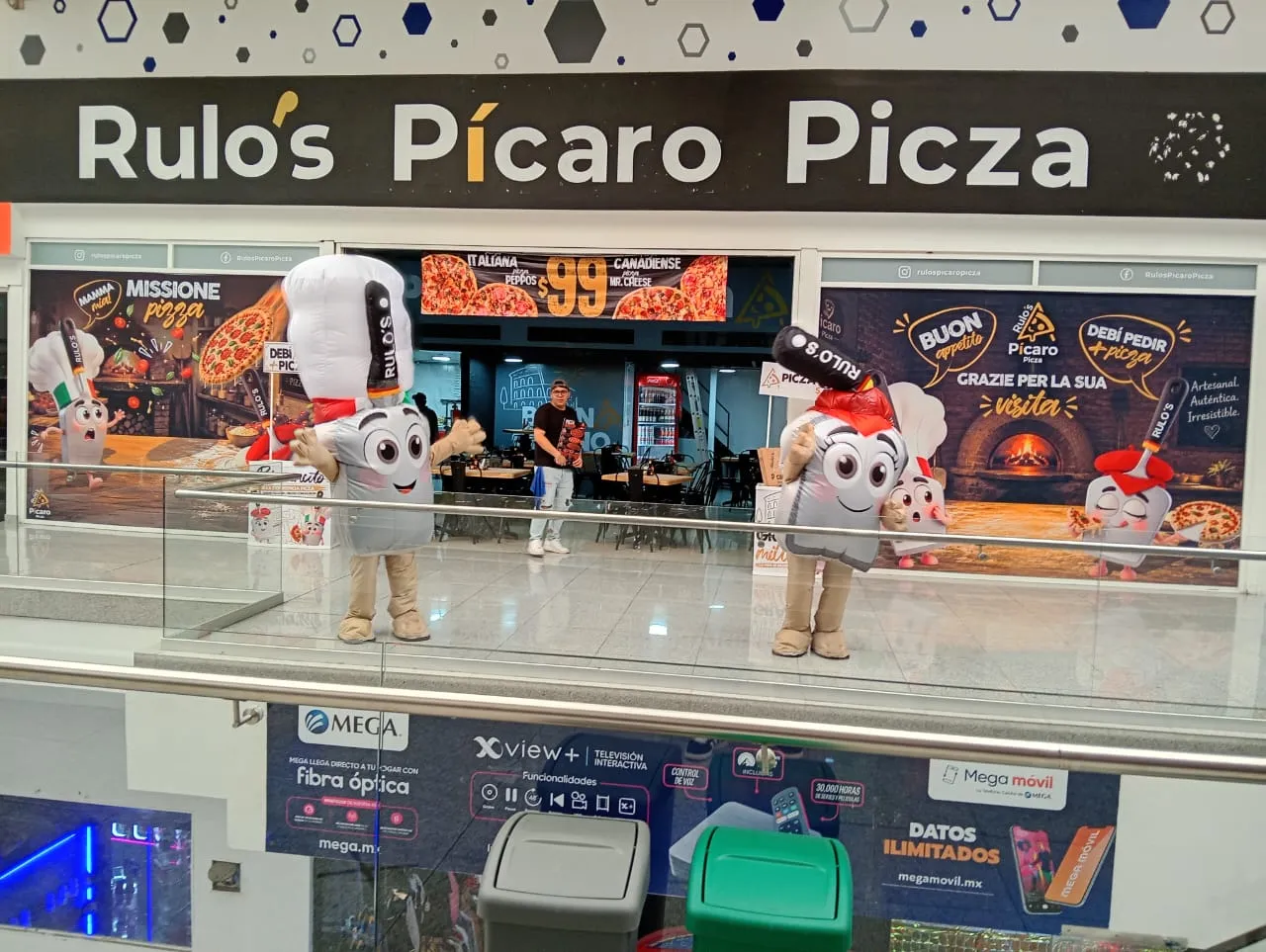 Pícaro y la Pícara saludando frente a la fachada